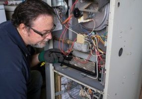 Guy Fixing Diagnosing Furnace Repair